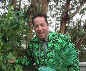 Alan Katz in cannabis leaf suit among plants